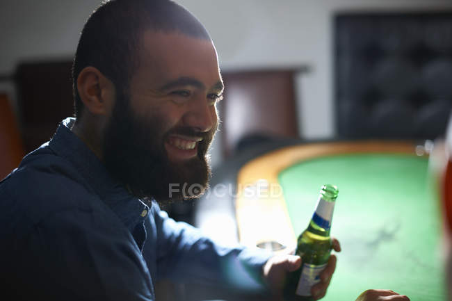 Over the shoulder view of men drinking beer at pub card table — Stock Photo
