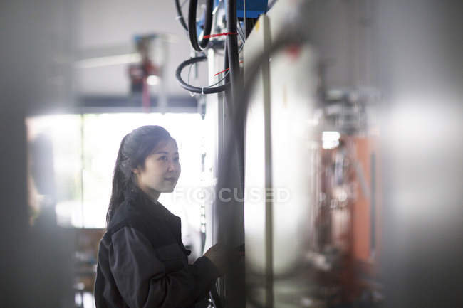 Technician operating machine in factory — Stock Photo