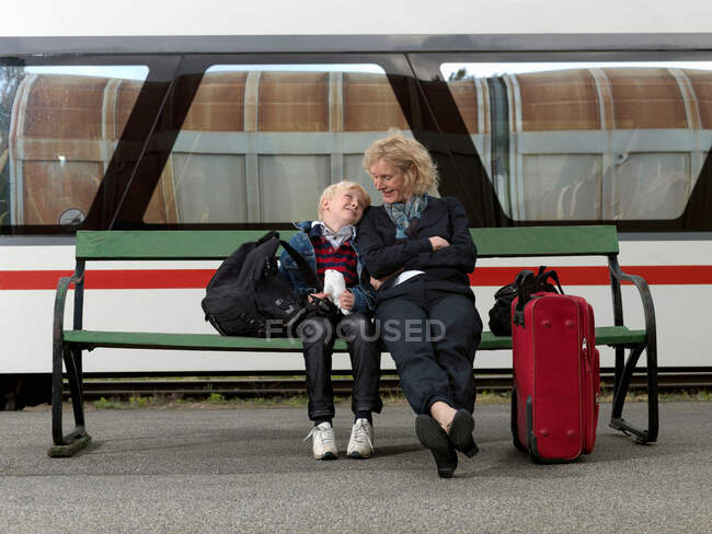 Grandmother and grandson on train station — Stock Photo