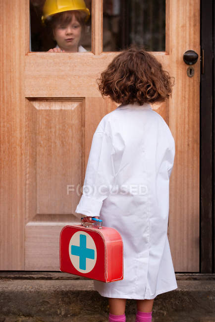 Girl playing doctor making house call — Stock Photo
