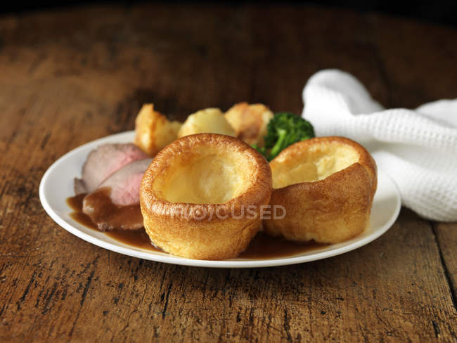 Plate of roast beef, yorkshire puddings, broccoli and potatoes — Stock Photo