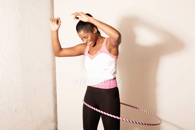 Portrait of young woman using plastic hoop — Stock Photo