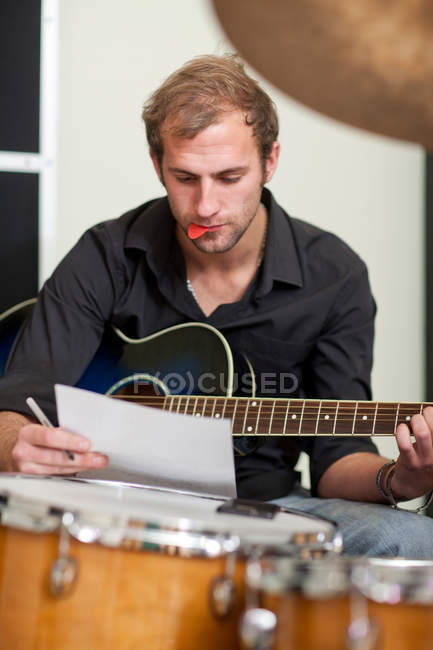 Young musician making notes — Stock Photo