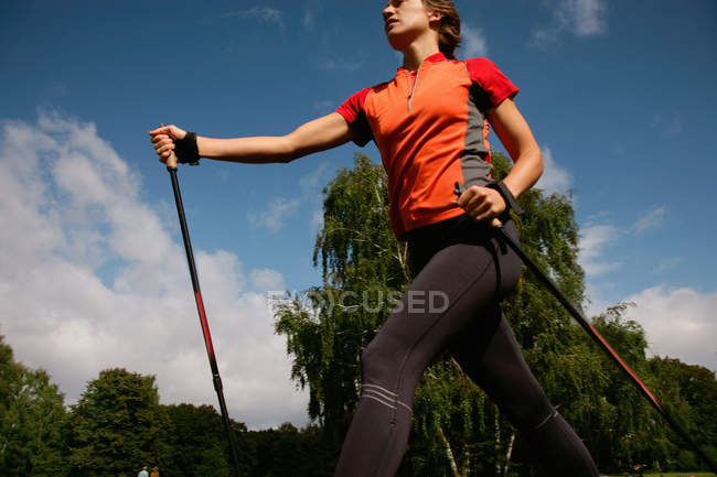 Low angle vie of Woman hiking in park — Stock Photo