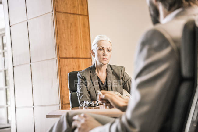 View over shoulder of businesswoman in meeting — Stock Photo