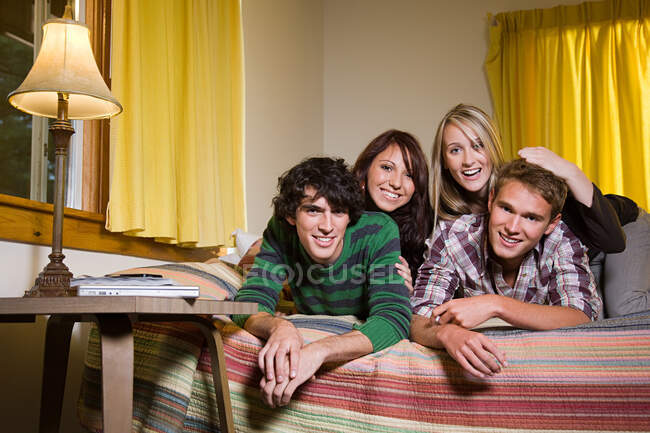 Friends lying on bed — Stock Photo