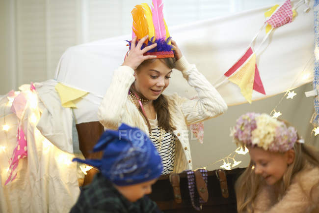 Boy and two sisters playing dress up from treasure chest — Stock Photo