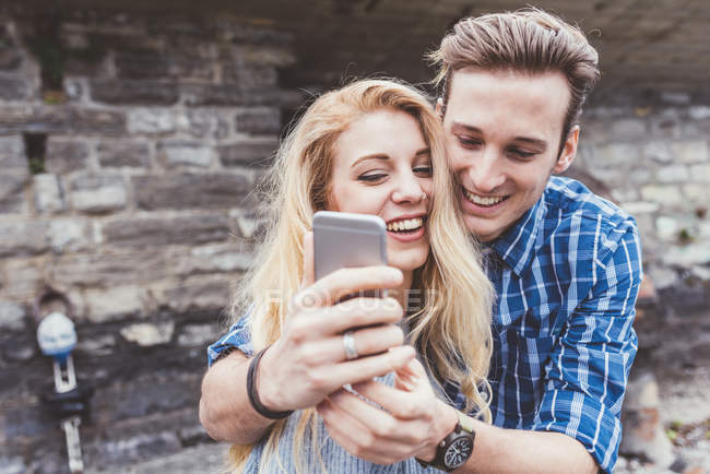 Young couple taking smartphone selfie, Lake Como, Italy — Stock Photo