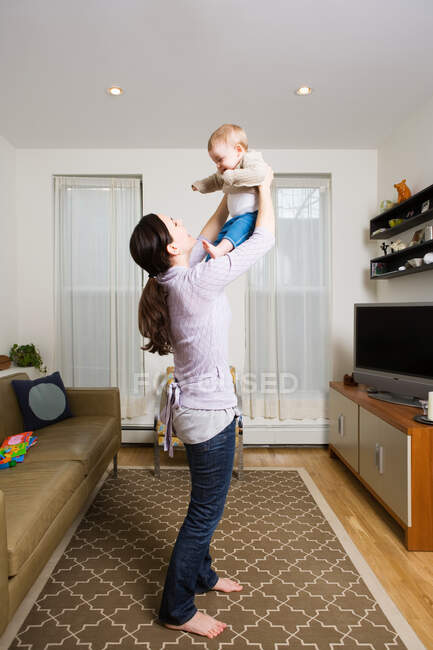 A mother lifting her baby — Stock Photo