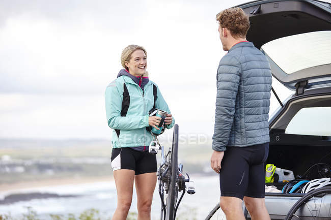 Cyclists preparing bicycle for ride near car — Stock Photo