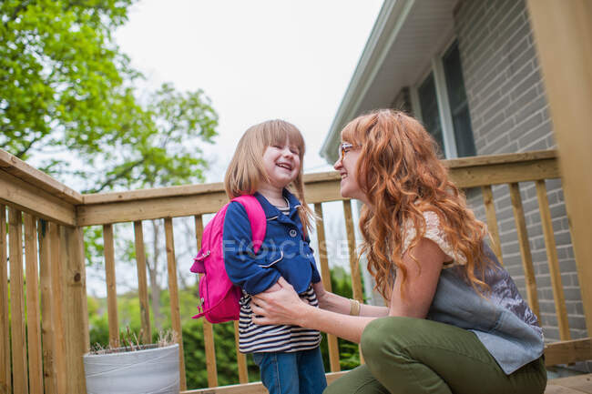 Mother and daughter standing on porch — Stock Photo
