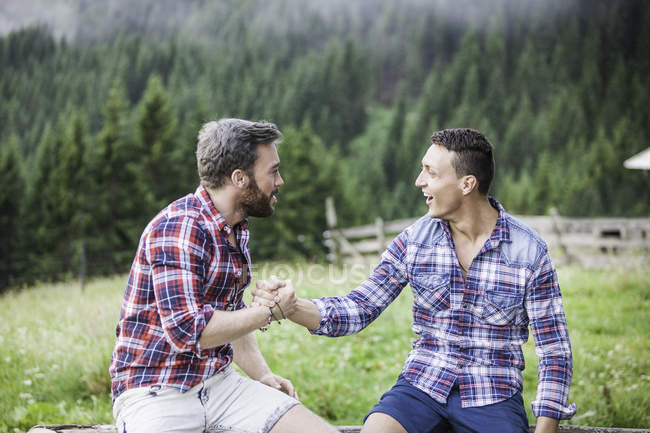 Two male friends shaking hands — Stock Photo