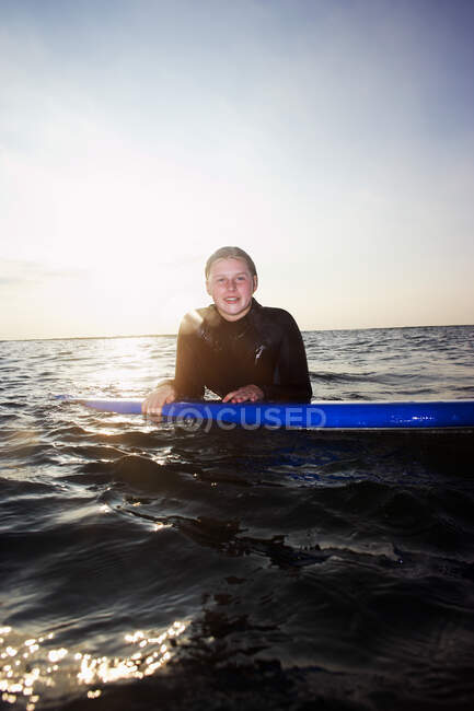 Female surfer floating in the surf — Stock Photo