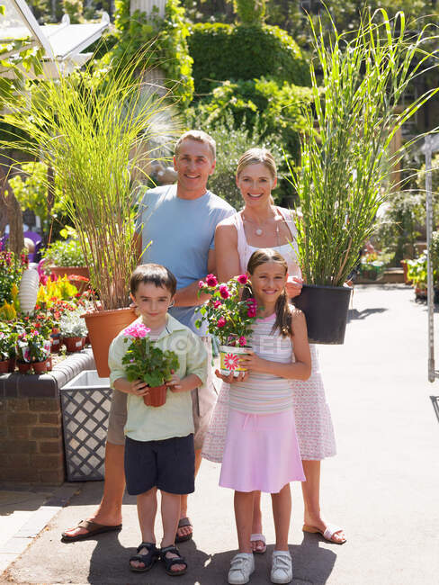 Family in a garden centre — Stock Photo