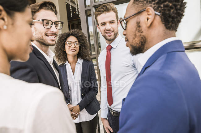 Businessmen and businesswomen having discussion outside office — Stock Photo