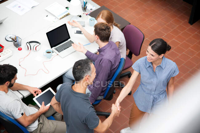 Colleagues shaking hands, high angle — Stock Photo