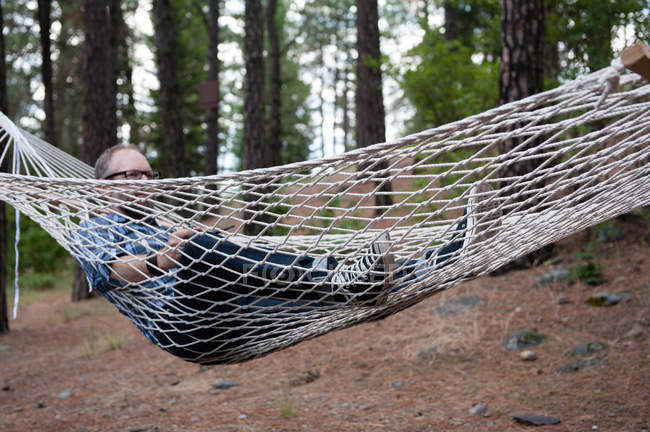 Man relaxing in hammock, Spokane, Washington, USA — Stock Photo