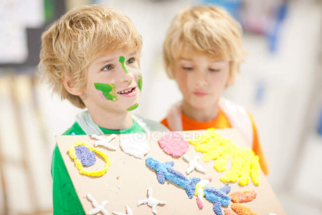 Boy showing his artistic creation — Stock Photo