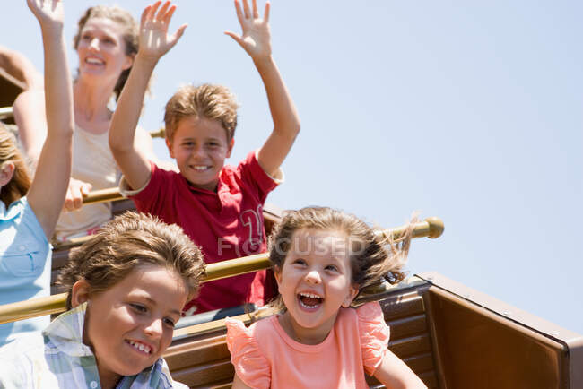 Kids on a roller coaster — Stock Photo