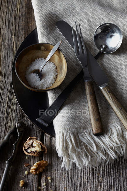 Bowl of salt and cutlery — Stock Photo