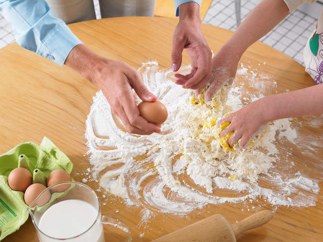 Woman and girl mixing ingredients — Stock Photo