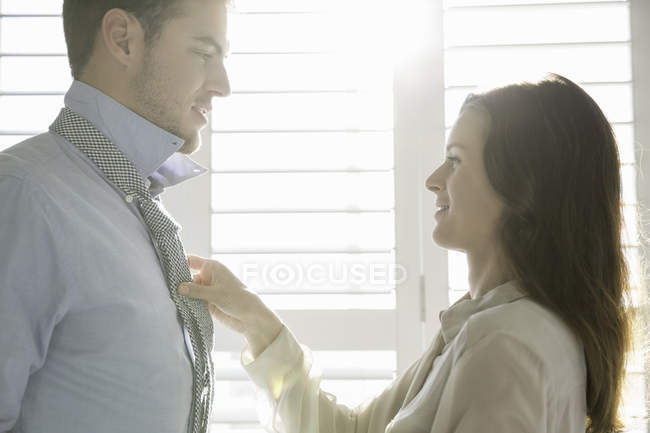 Young businesswoman fastening business boyfriends tie — Stock Photo