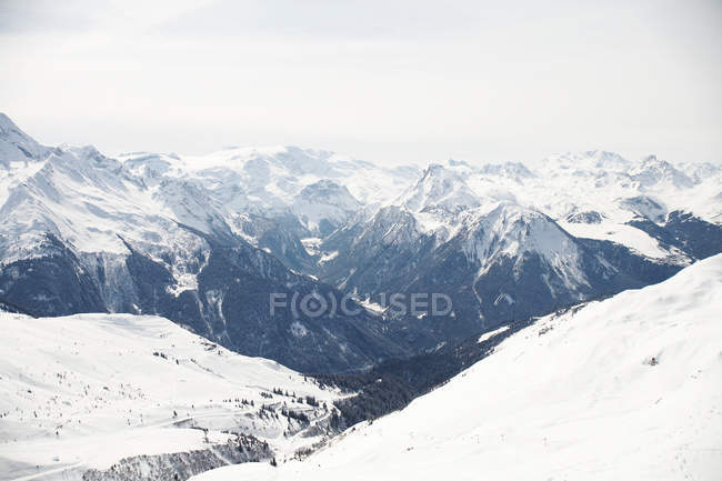 Snow covered mountains with cloudy sky — Stock Photo