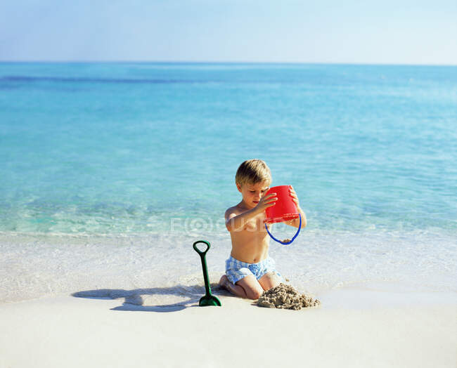 Menino brincando com areia — Fotografia de Stock