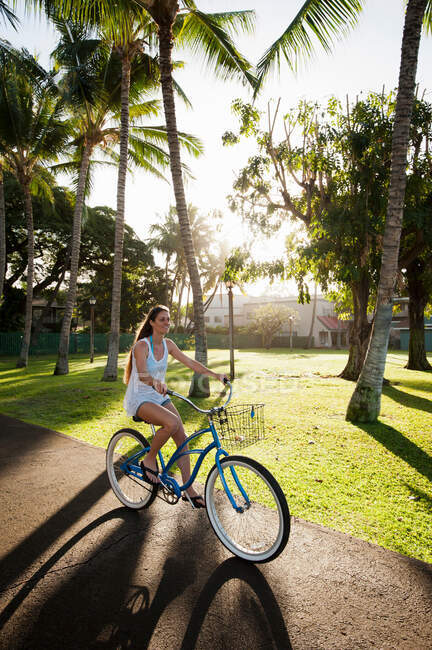 Woman riding bicycle in park — Stock Photo