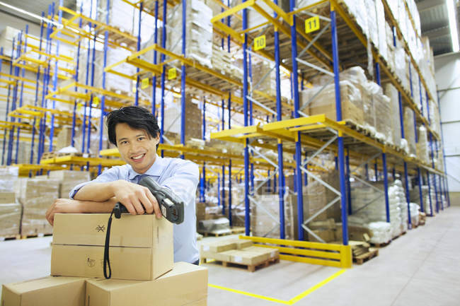 Portrait of handsome Asian male manager in distribution warehouse — Stock Photo