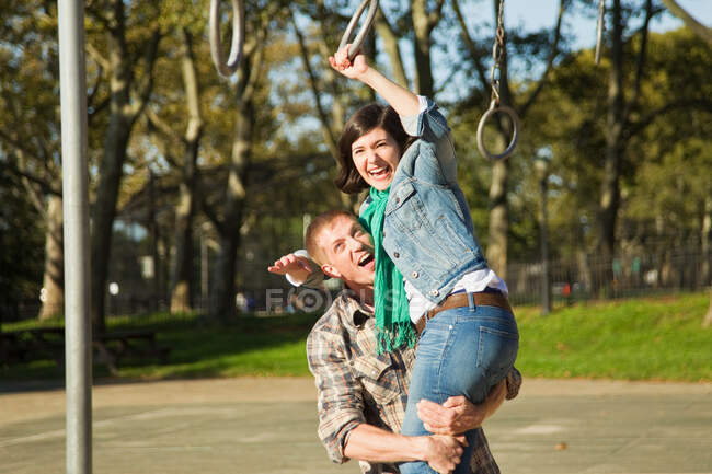 Couple playing in children's playground — Stock Photo