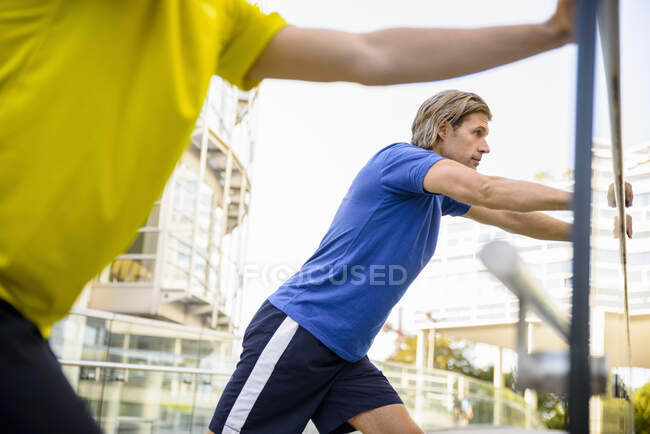 Two men leaning and stretching — Stock Photo