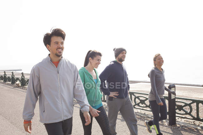 Male and female runners preparing to run at Brighton beach — Stock Photo