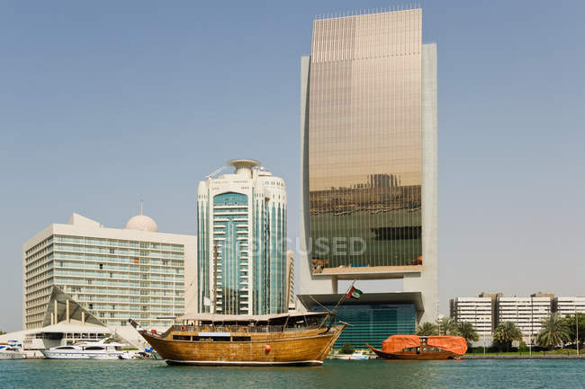 Harbour with skyscrapers and boat — Stock Photo
