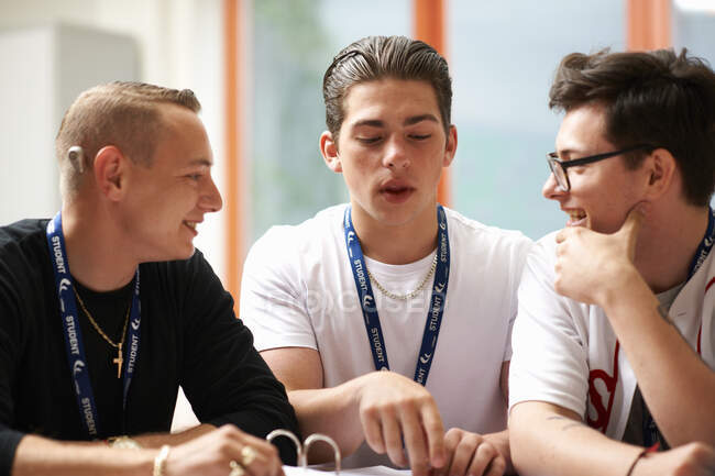 Three male students working together in class — Stock Photo
