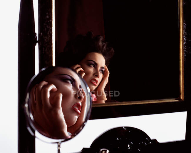 Жіноче обличчя відображено у двох дзеркалах — стокове фото