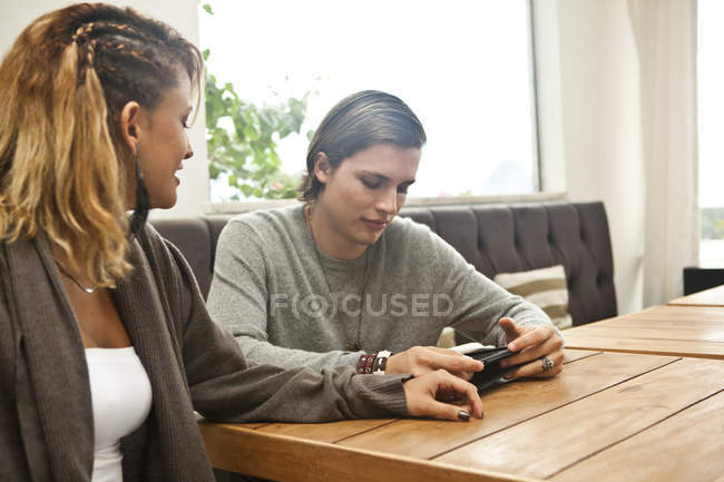Coppia giovane che utilizza tablet digitale nella hall dell'hotel — Foto stock