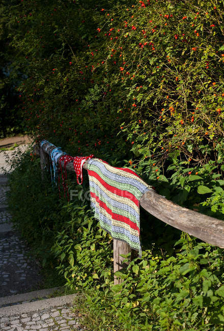 Tapestries hanging over fence — Stock Photo