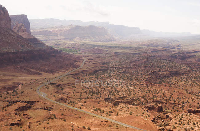 Elevated view of distant rural road in valley, Capitol Reef National Park, Torrey, Utah, USA — Stock Photo
