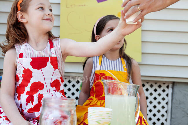Girls selling homemade lemonade — Stock Photo