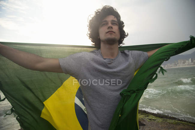 Young Man Holding Up Brazilian Flag Ipanema Beach Rio De Janeiro Brazil Building Exterior Patriotism Stock Photo