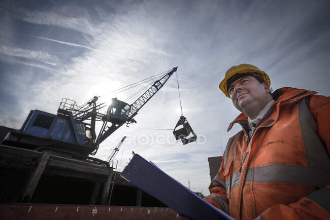 Low angle view of load master checking ship loading — Stock Photo
