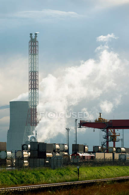 Containers on train by chemical plant — Stock Photo