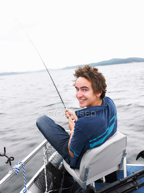 Portrait of Man fishing on boat — Stock Photo