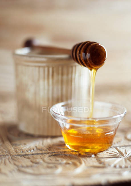 Honey dripping from spoon — Stock Photo