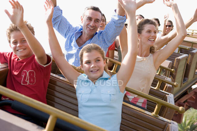 Family riding on rollercoaster — Stock Photo