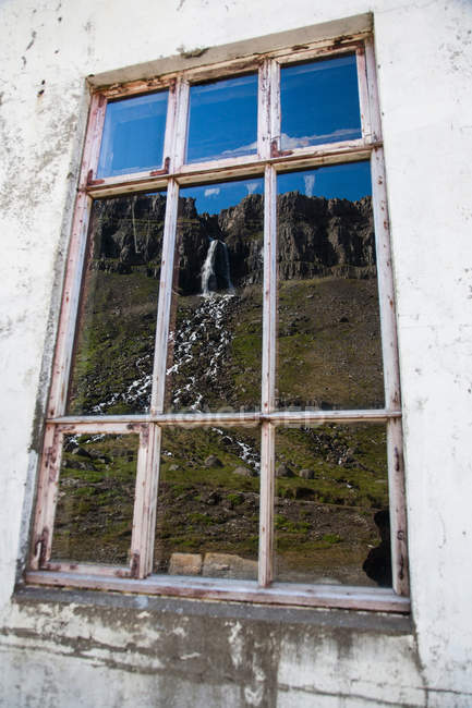 Rural waterfall reflected in window — Stock Photo