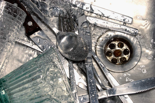 Close up of Wet culery in sink — Stock Photo