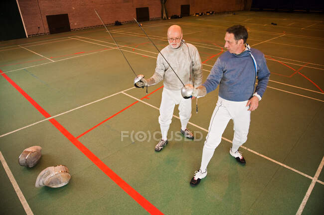 Senior and mature men fencing together — Stock Photo