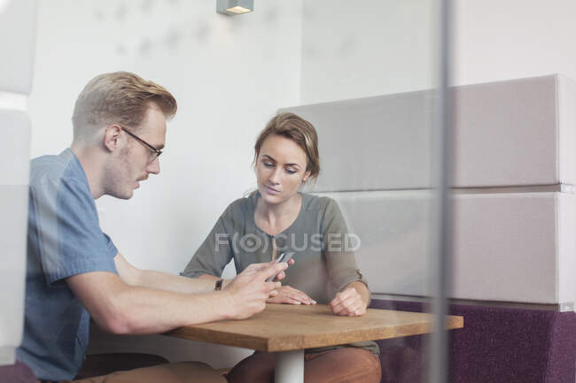 Colleagues looking at digital tablet in meeting — Stock Photo
